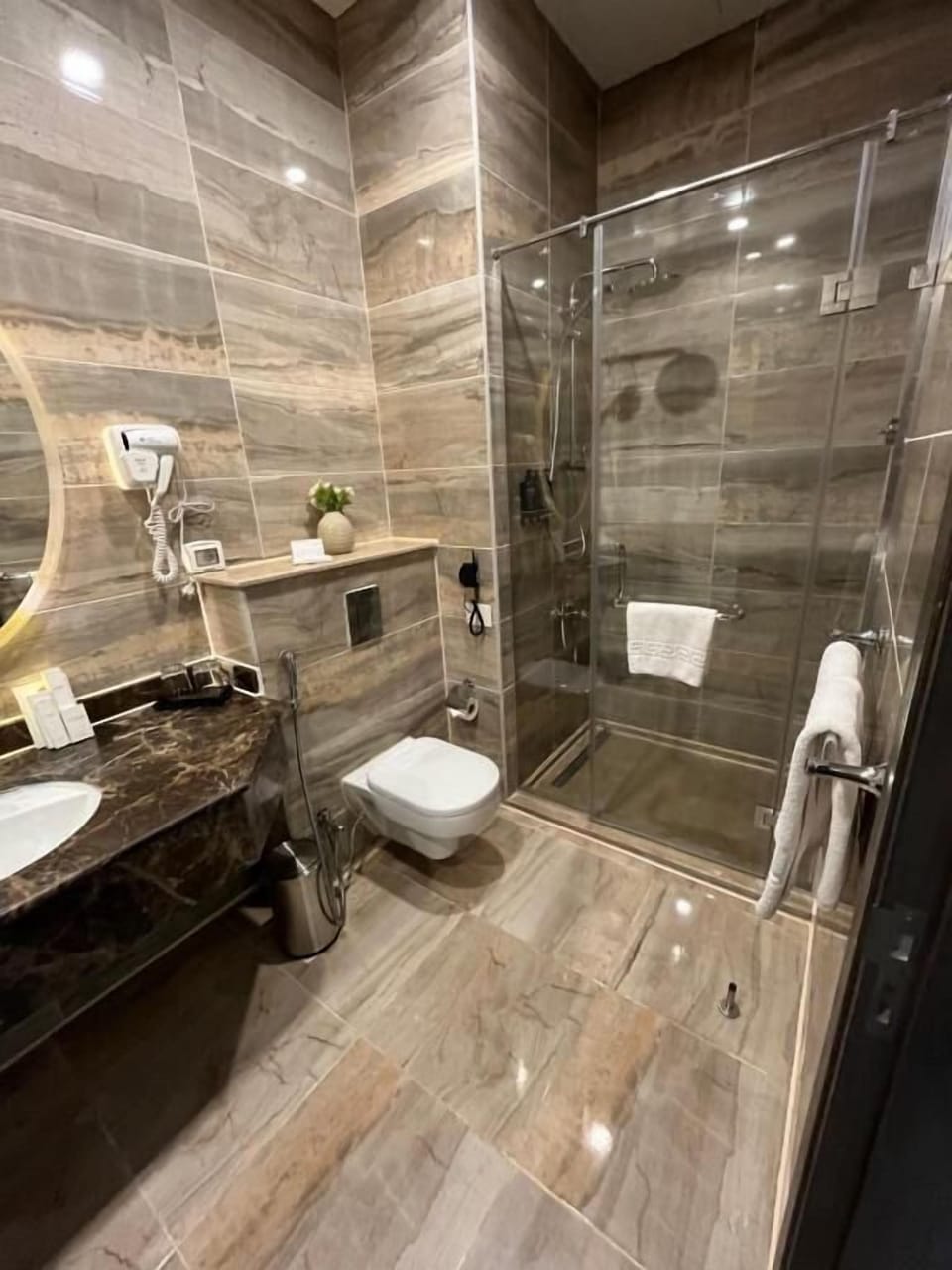 Shower, hair dryer, slippers, towels
