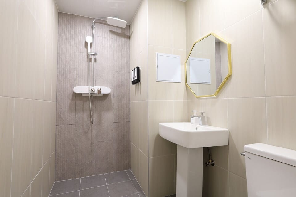 Business Room | Bathroom | Rainfall showerhead, designer toiletries, hair dryer, bathrobes