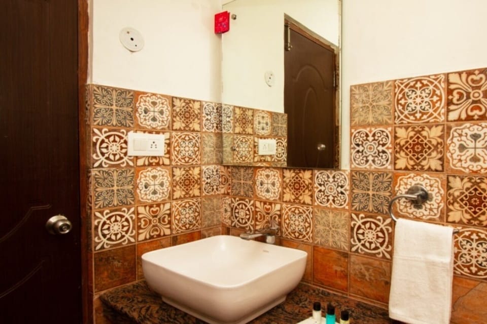 Shower, designer toiletries, slippers, towels