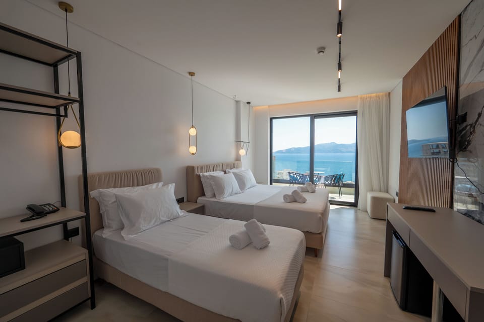 Superior Triple Room, Balcony, Sea View | Minibar, in-room safe, desk, blackout drapes