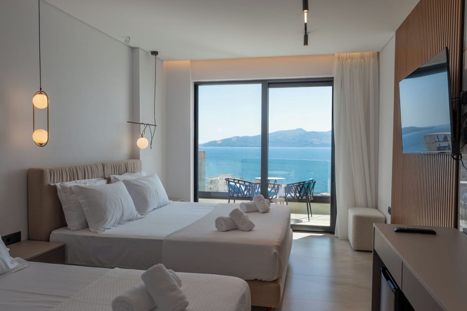 Superior Triple Room, Balcony, Sea View | Minibar, in-room safe, desk, blackout drapes