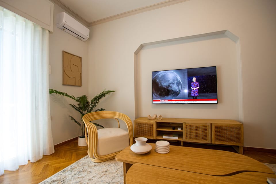 Design Apartment | Living area | 49-inch Smart TV with cable channels