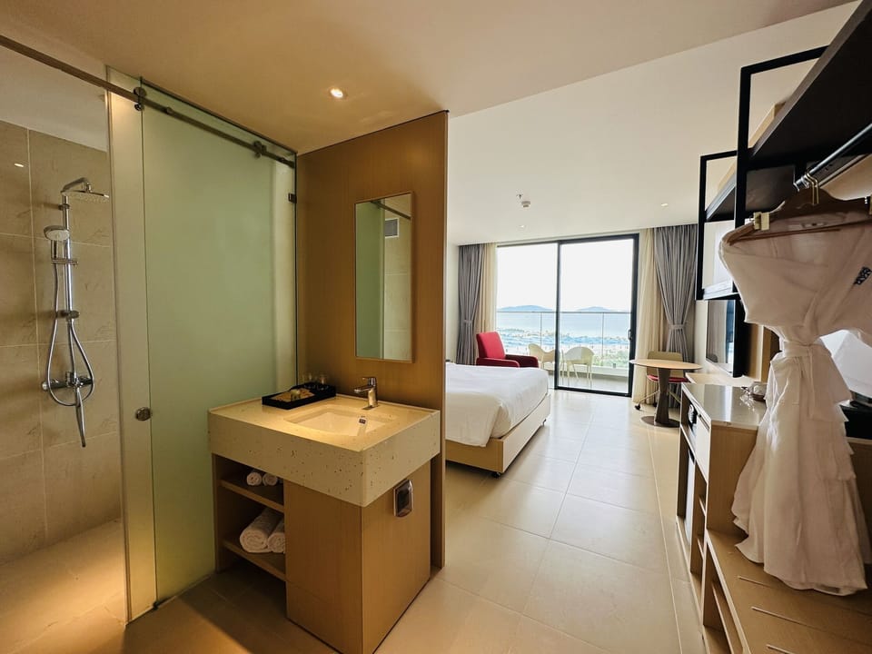 Deluxe Double Room, Partial Ocean View | In-room safe, blackout drapes, iron/ironing board, WiFi (free)