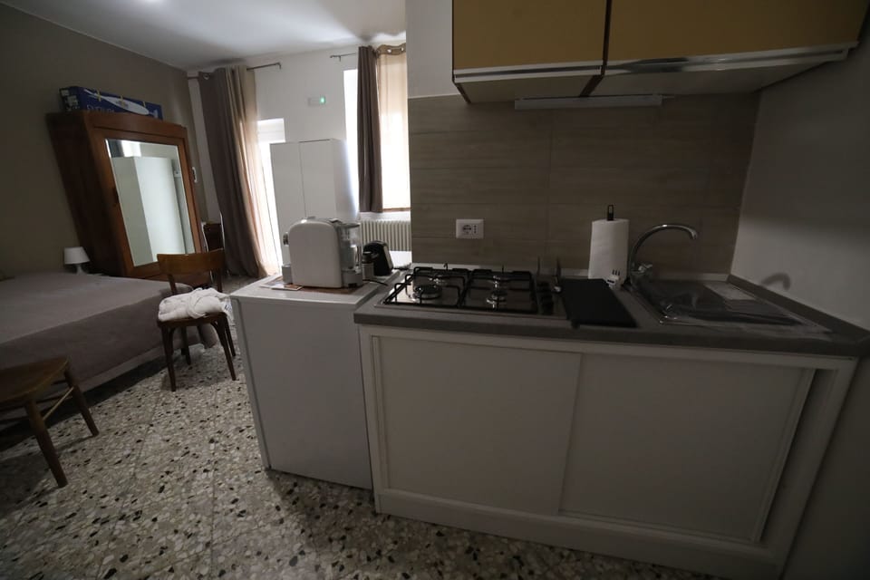 Comfort Quadruple Room, Courtyard View | Private kitchen | Full-size fridge, stovetop, espresso maker, coffee/tea maker