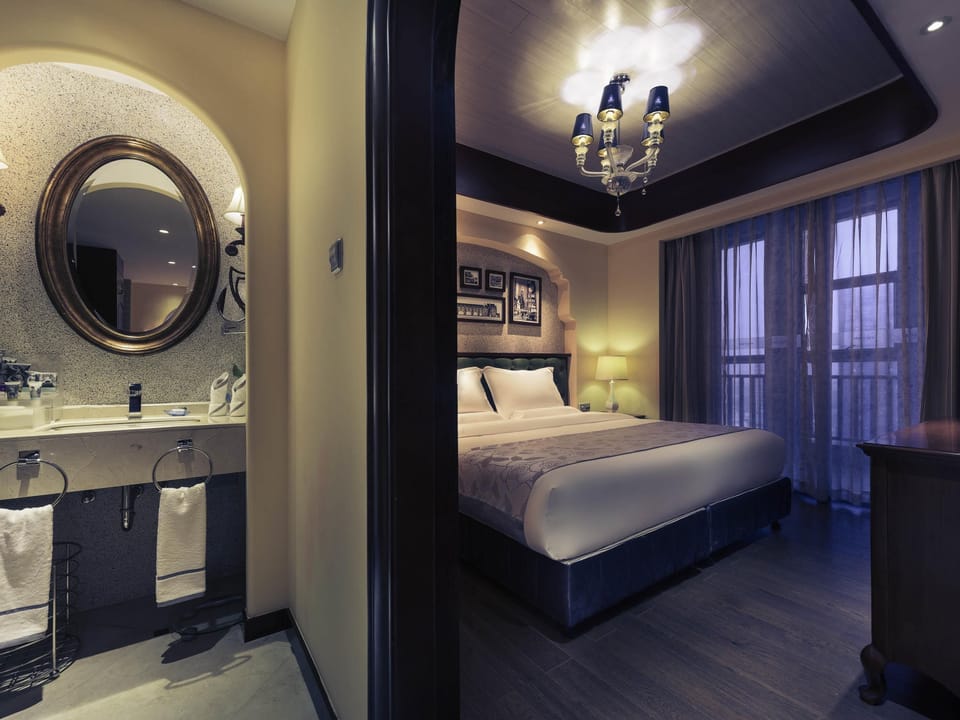 Deluxe Double Room Single Use, 1 King Bed | In-room safe, individually decorated, desk, iron/ironing board