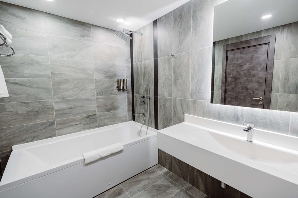 Suite, Multiple Beds, Non Smoking, Kitchenette (Separate Living Room;with Sofabed) | Bathroom | Rainfall showerhead, free toiletries, hair dryer, bathrobes