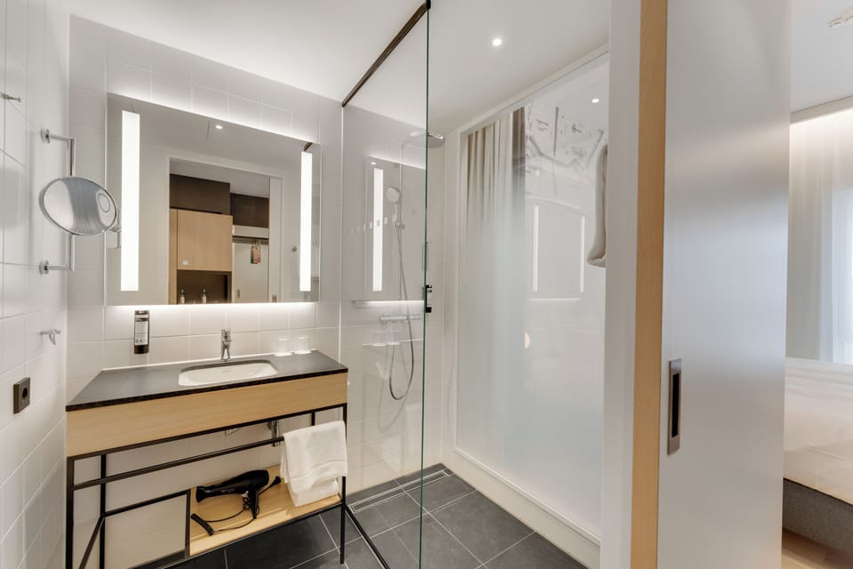 Shower, rainfall showerhead, hair dryer, towels