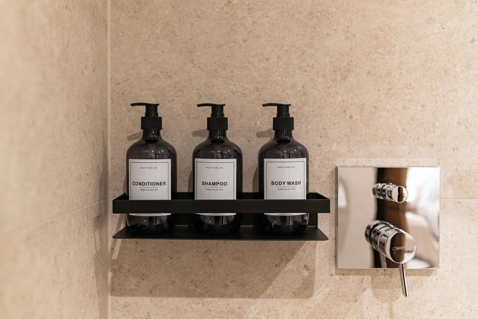 Shower, rainfall showerhead, hair dryer, towels