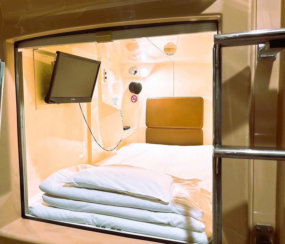 Male Standard Capsule Lower Bunk, Check out must by 10AM each day, Tattoos not allowed, Non Smoking | Blackout drapes, free WiFi, bed sheets