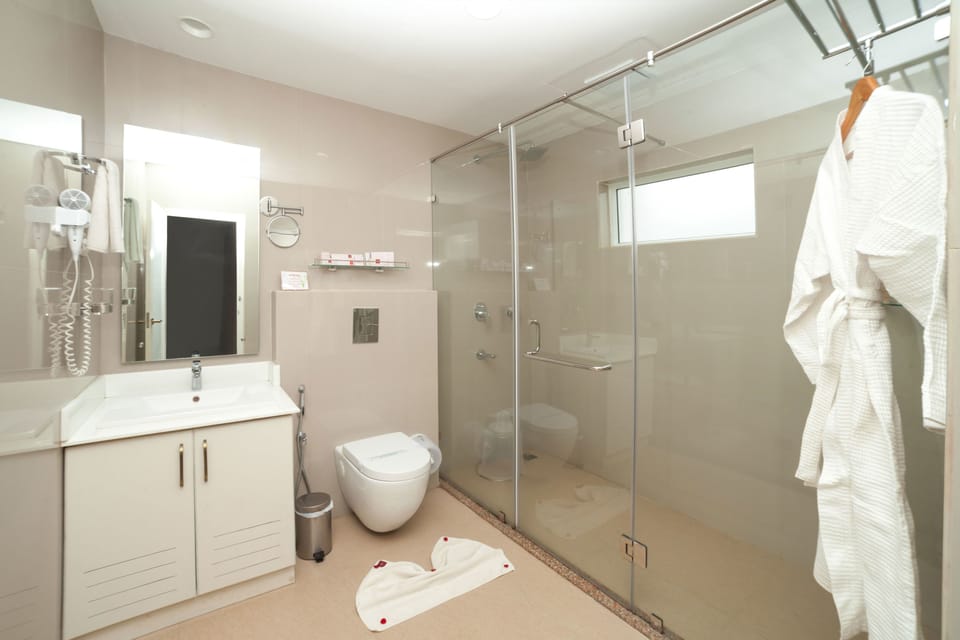 Shower, rainfall showerhead, designer toiletries, hair dryer