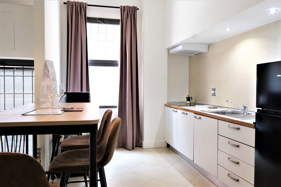 City Apartment | Living area | 35-inch flat-screen TV with satellite channels