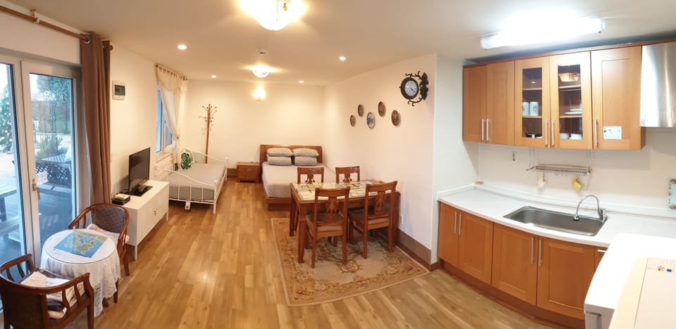 Studio, Garden View | Living area | Flat-screen TV