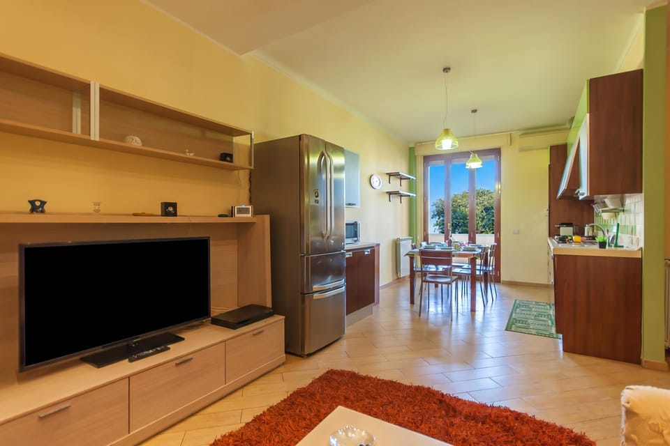Family Apartment, 2 Bedrooms, Balcony (Happy Apartment Nettuno Close To Sea) | Living room | Flat-screen TV