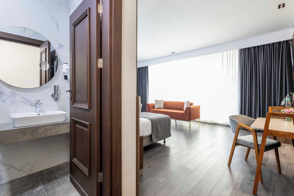 Corner Family Suite | Bathroom | Hair dryer, slippers, towels, soap
