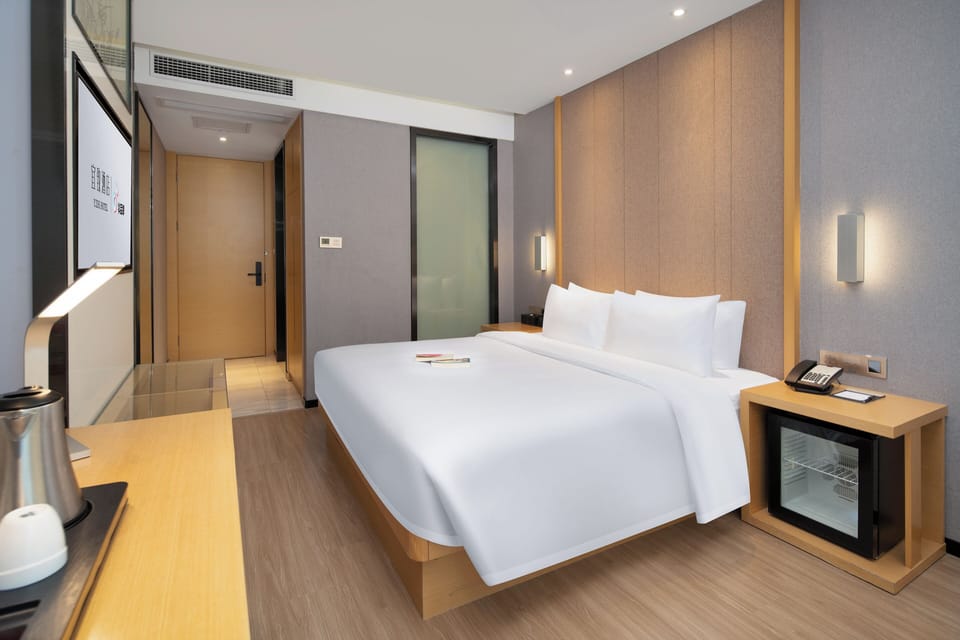 Premium bedding, desk, laptop workspace, blackout drapes