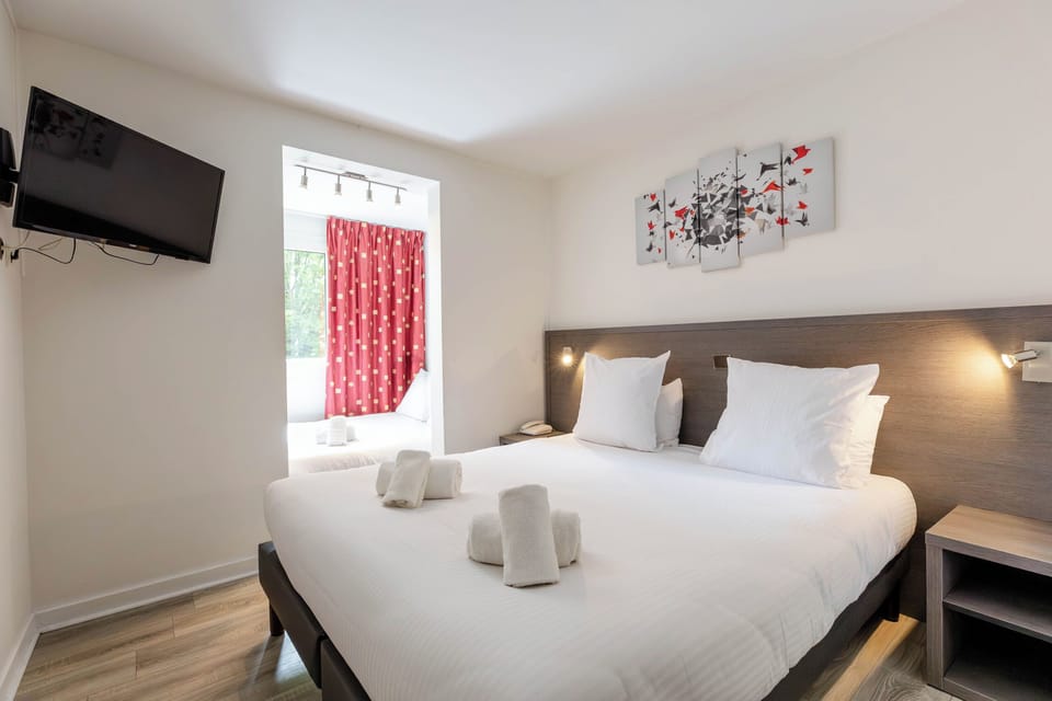 Comfort Room | Premium bedding, desk, blackout drapes, soundproofing