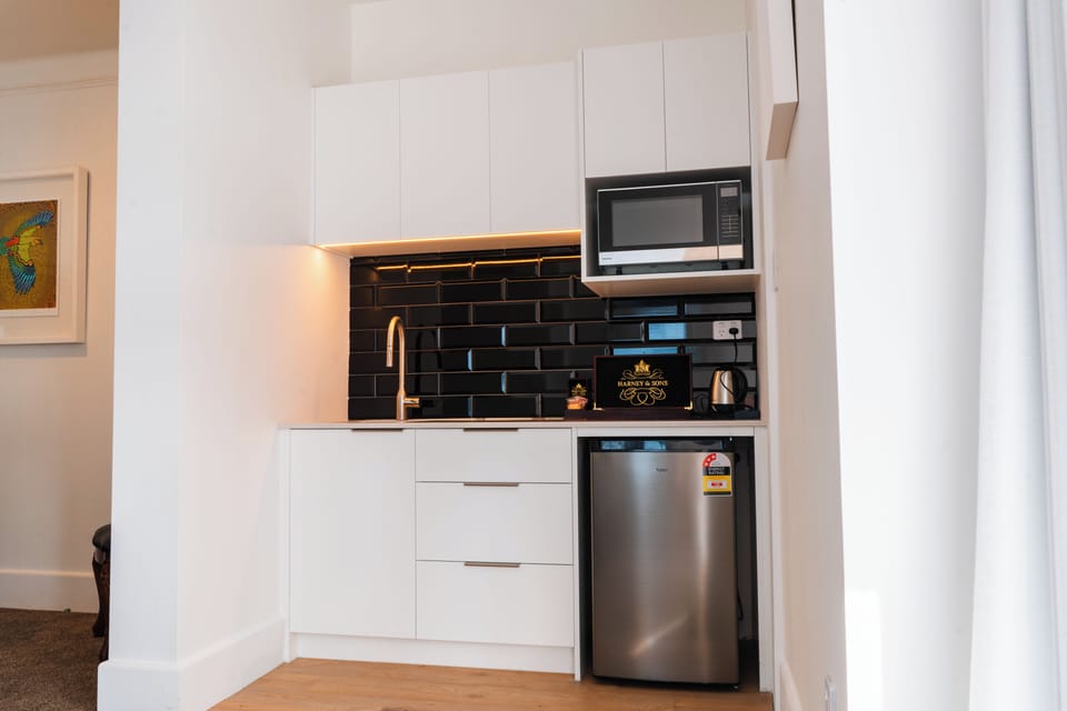 Waterfront Apartment | Private kitchen | Fridge, electric kettle