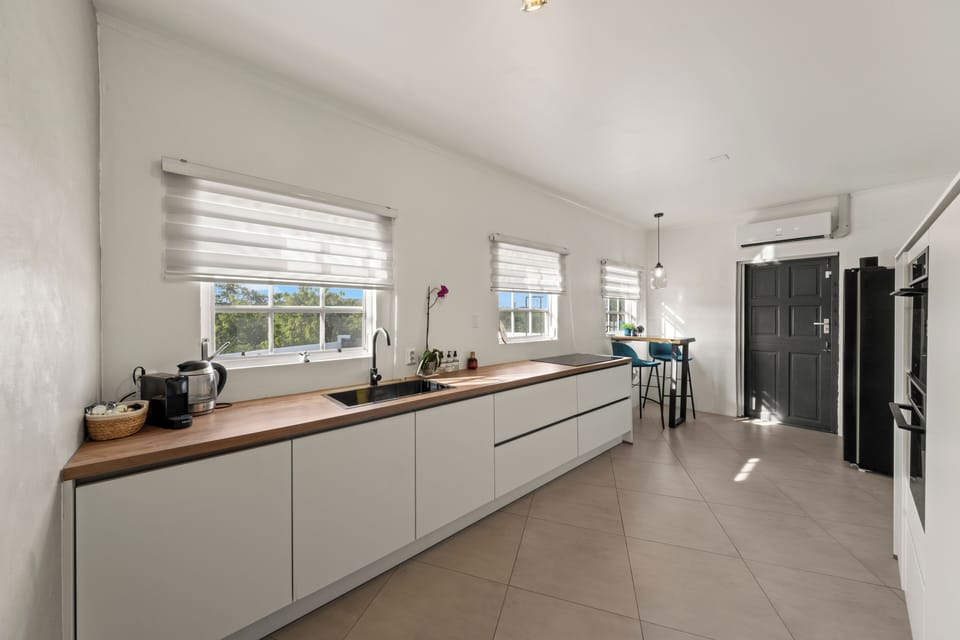 Deluxe Apartment, 1 King Bed | Private kitchen | Shared fridge, microwave, dining tables