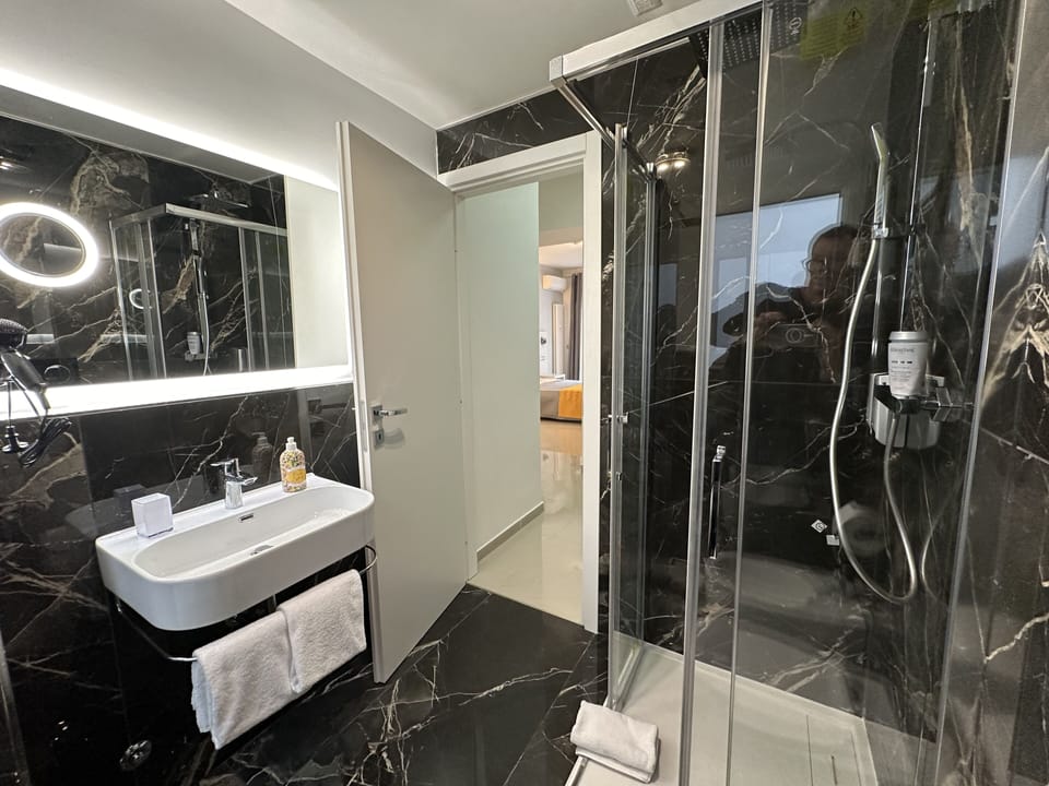Deluxe Double Room, Park View | Bathroom | Shower, slippers, towels
