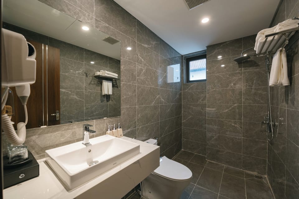 Superior Room | Bathroom | Hair dryer, slippers, bidet, towels