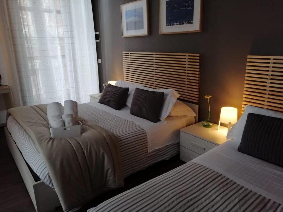Classic Quadruple Room, City View | Down comforters, desk, laptop workspace, blackout drapes