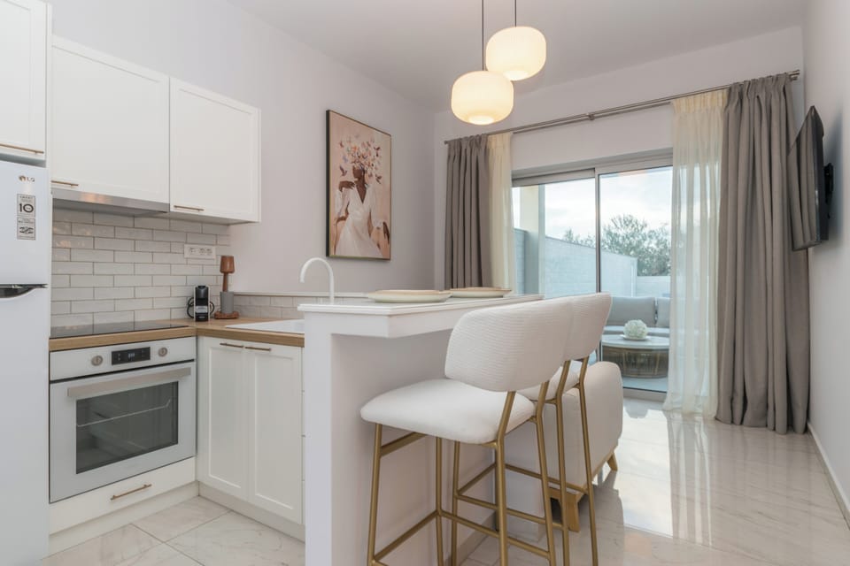 Luxury Suite, Pool View | Private kitchen | Full-size fridge, oven, stovetop, espresso maker