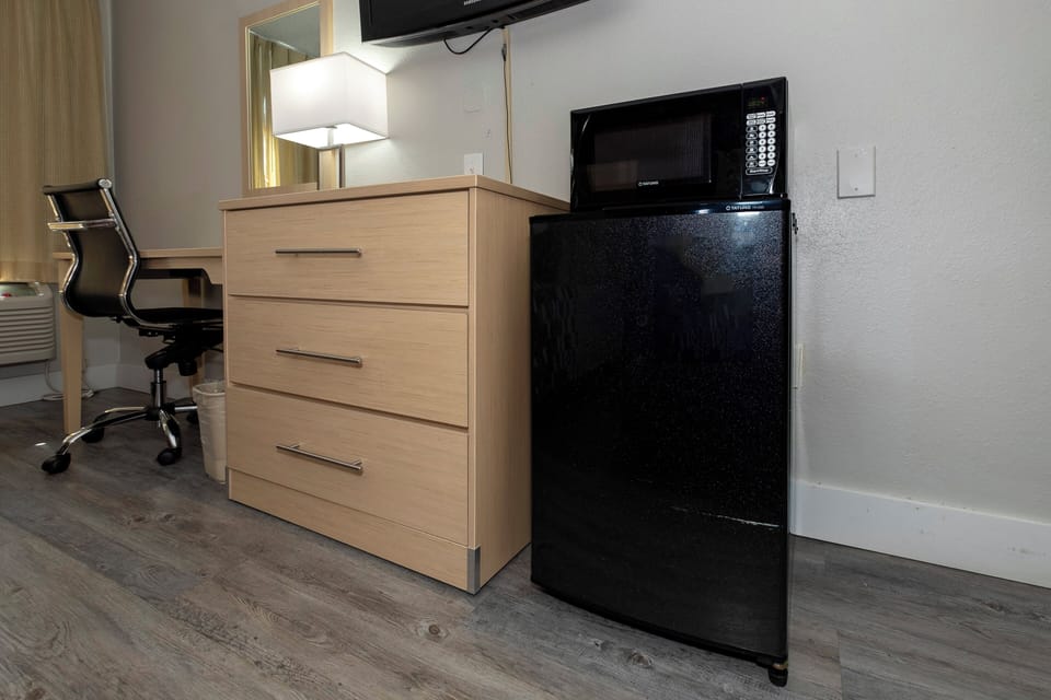 Desk, laptop workspace, blackout drapes, iron/ironing board