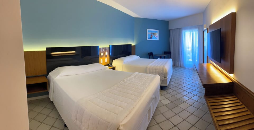 Deluxe Quadruple Room, Pool View | In-room safe, desk, laptop workspace, blackout drapes