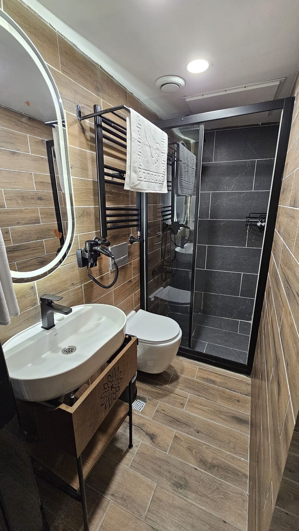 Shower, hair dryer, slippers, towels