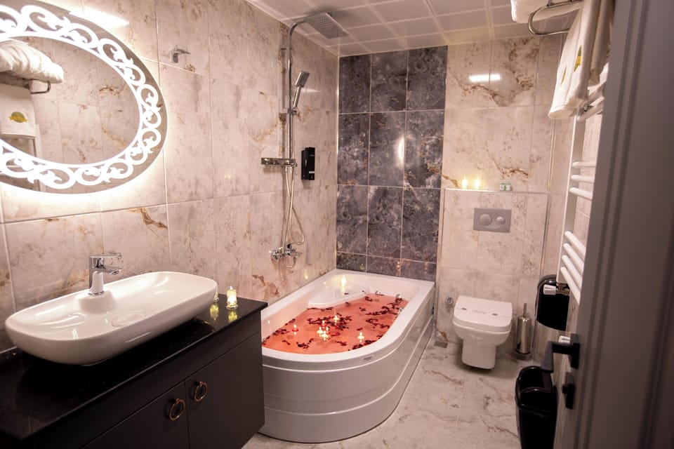 Deluxe Studio Suite, Sea View | Bathroom | Shower, hair dryer, slippers, towels