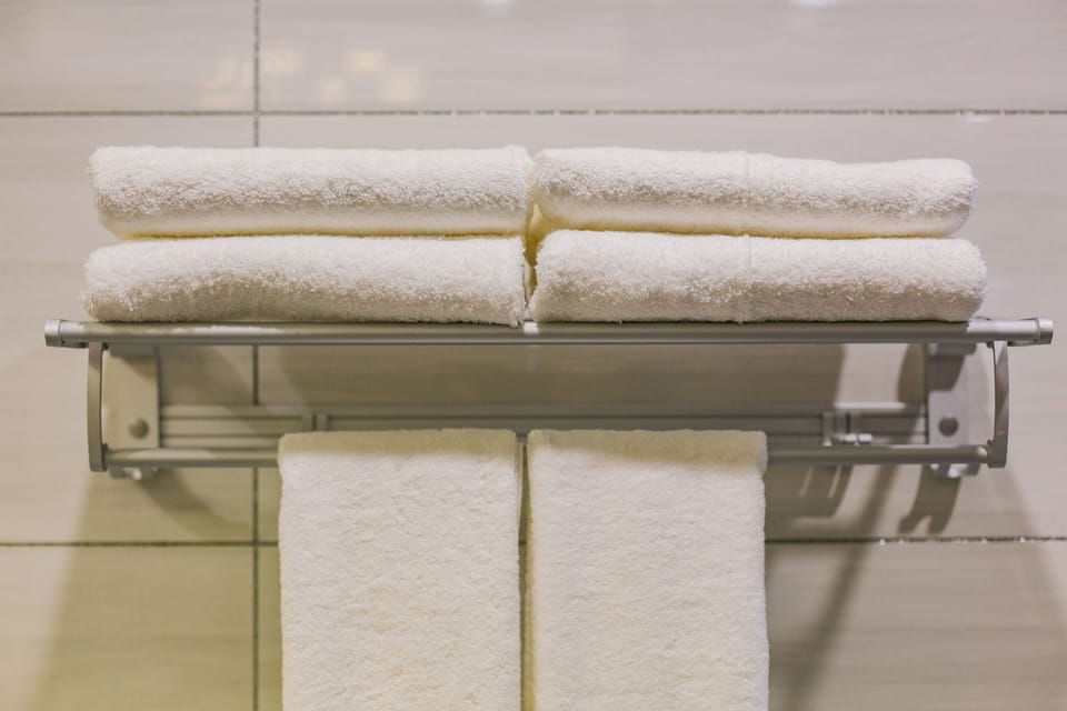 Shower, hair dryer, slippers, towels