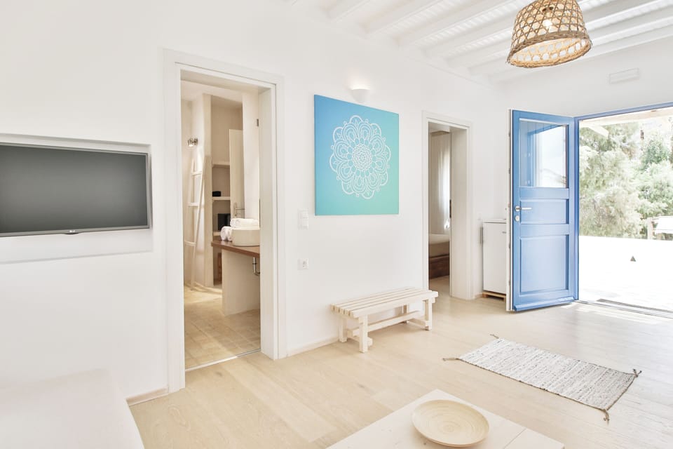 Suite, Patio, Partial Sea View | Living area | 85-cm flat-screen TV with cable channels