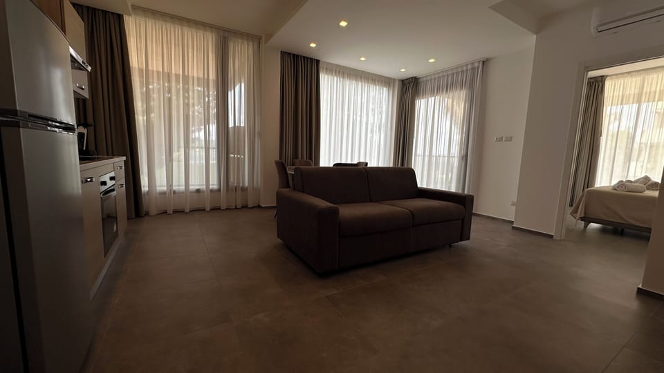Deluxe Apartment, Garden View | Living area | 43-inch Smart TV with cable channels