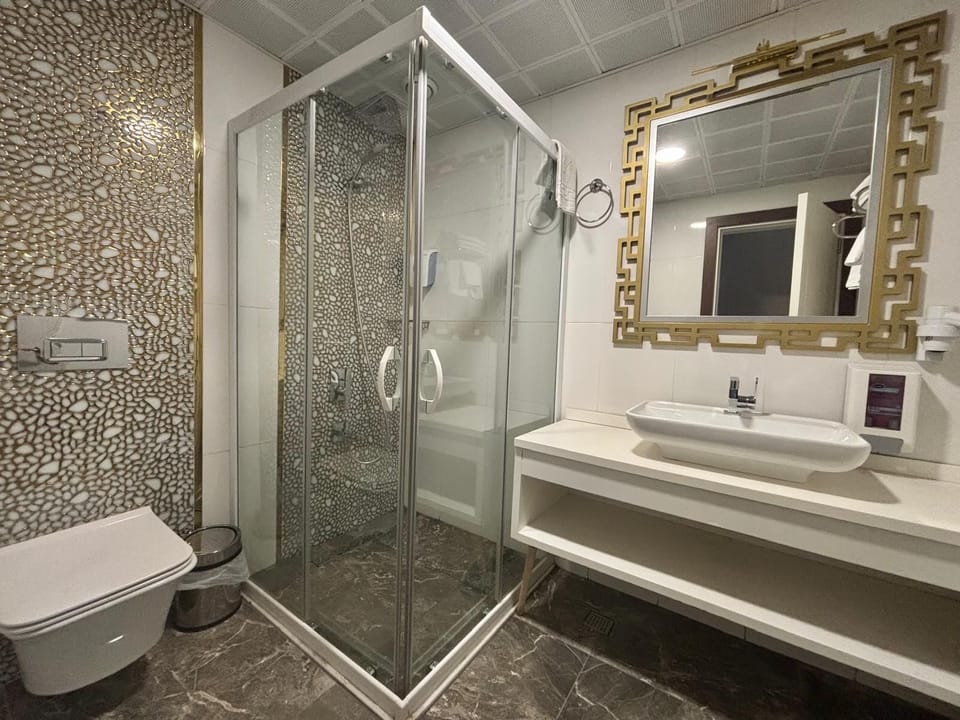 Shower, rainfall showerhead, hair dryer, towels
