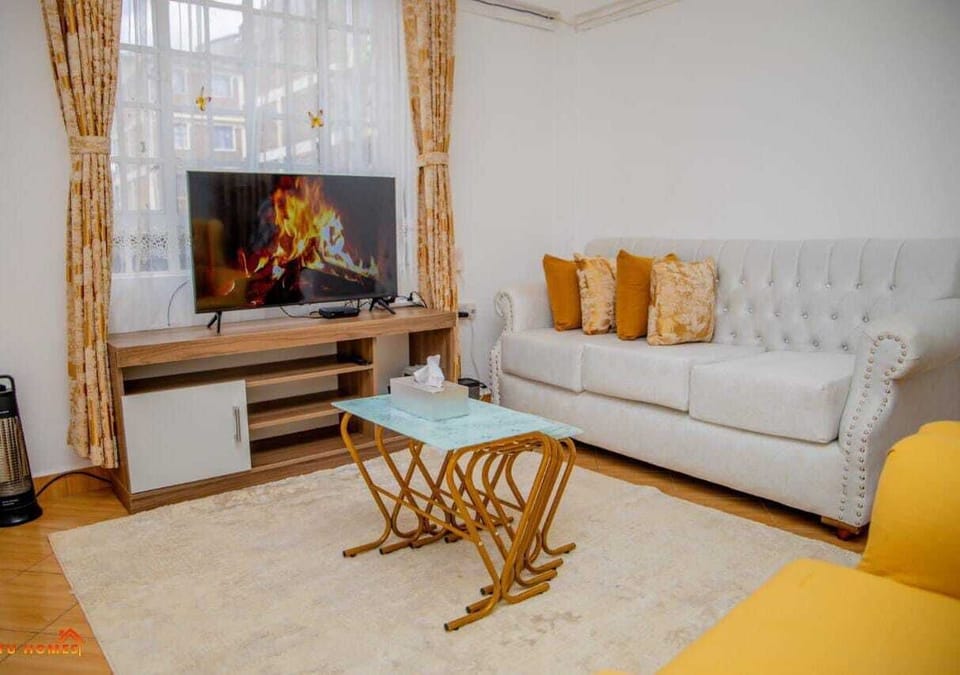 Comfort Apartment, City View | Living area | 24-inch Smart TV with digital channels