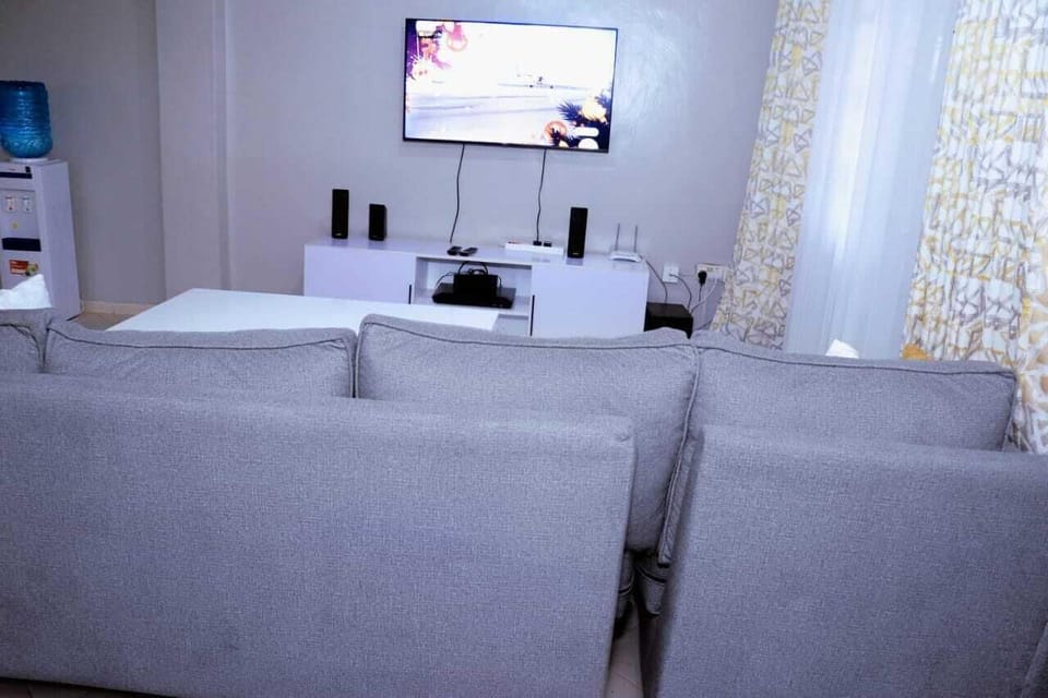 Deluxe Apartment, City View | Living area | 64-inch Smart TV with digital channels
