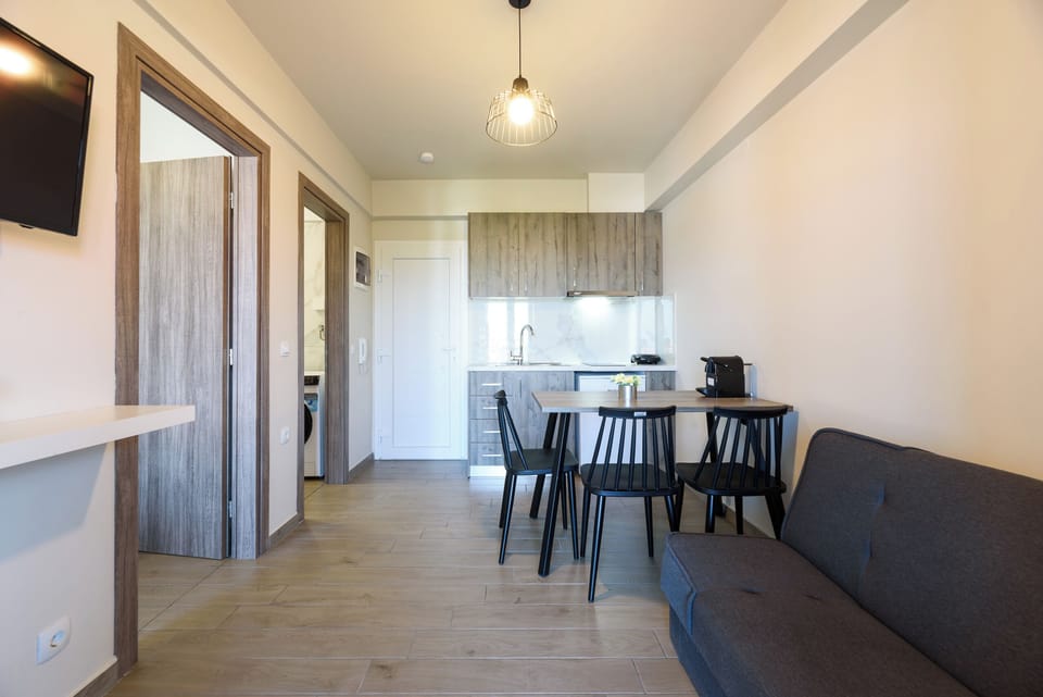 Family Apartment, Garden View | Living area | 43-inch Smart TV with satellite channels