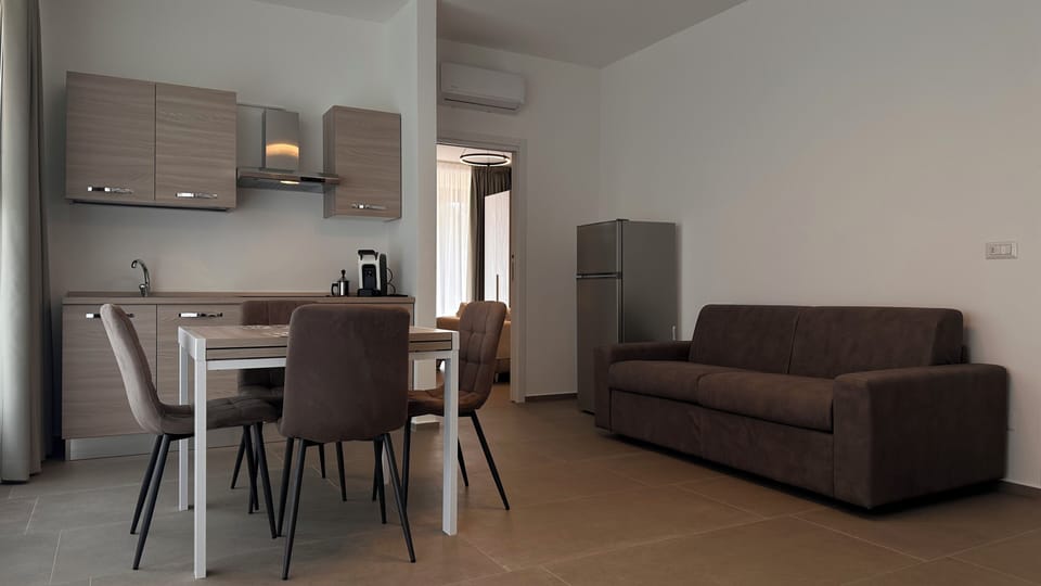 Deluxe Apartment, Kitchen, Garden Area | Living area | Flat-screen TV