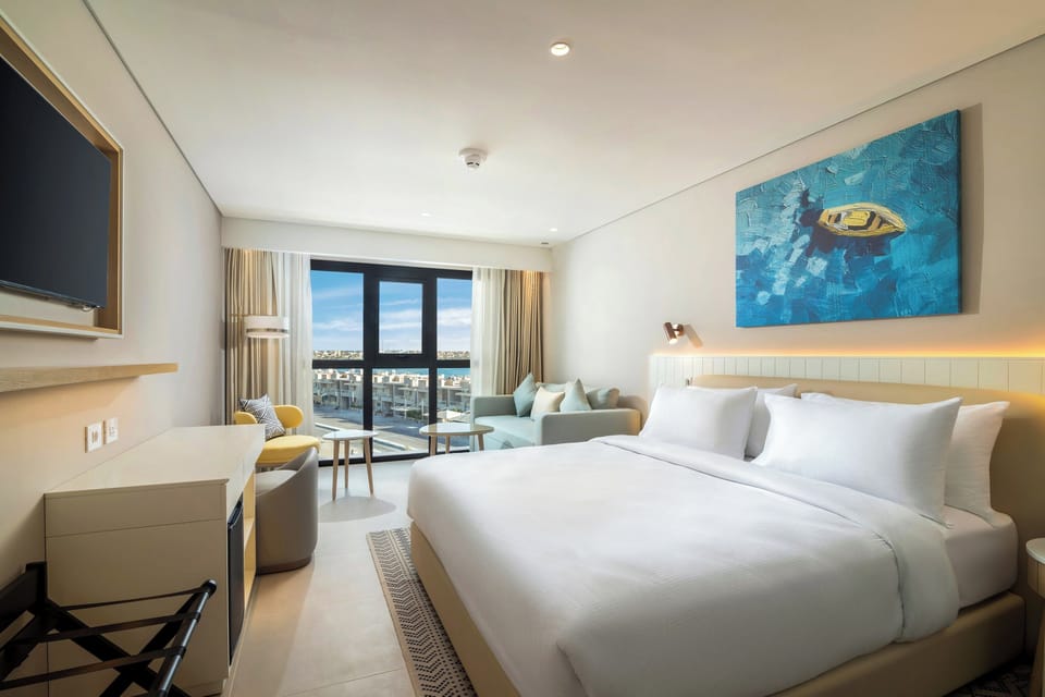 Room, 1 King Bed (Guest) | Minibar, in-room safe, iron/ironing board, free cribs/infant beds