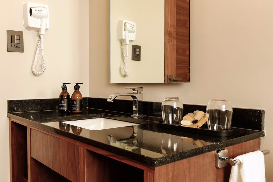 Bathtub, eco-friendly toiletries, hair dryer, towels