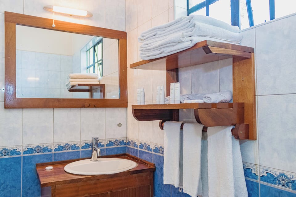 Deluxe Quadruple Room, Non Smoking, Balcony | Bathroom | Combined shower/tub, hair dryer, slippers, towels