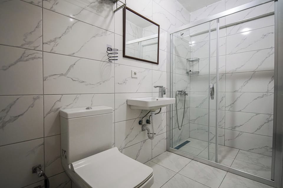 Economy Quadruple Room, Multiple Beds, Basement Floor | Bathroom | Shower, towels, soap, shampoo