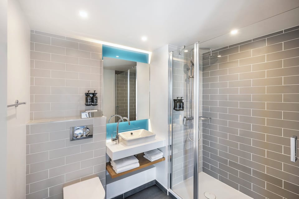 Shower, rainfall showerhead, hair dryer, towels