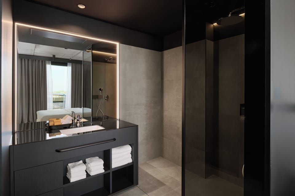 Shower, designer toiletries, hair dryer, bathrobes