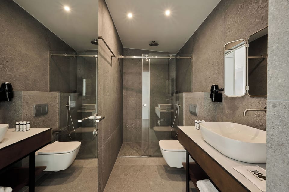 One Bedroom Suite with Balcony | Bathroom | Shower, slippers, towels, soap