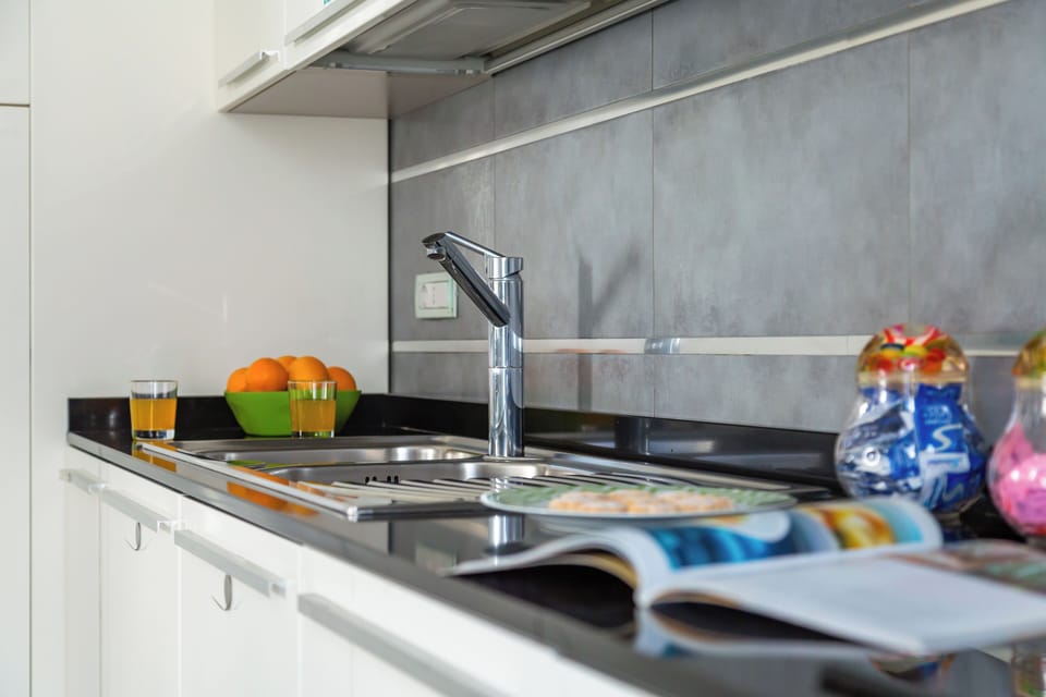 Apartment, Balcony, City View | Private kitchen | Espresso maker, electric kettle, highchair