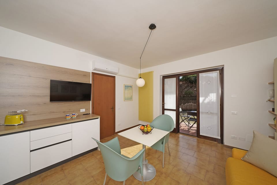 Apartment, Pool View | Living area | 35-inch TV with digital channels