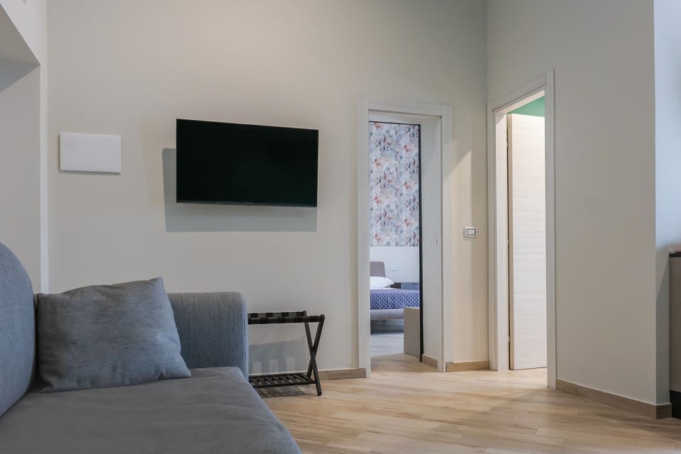 Family Suite, Balcony, City View | Living room | 50-inch Smart TV with digital channels