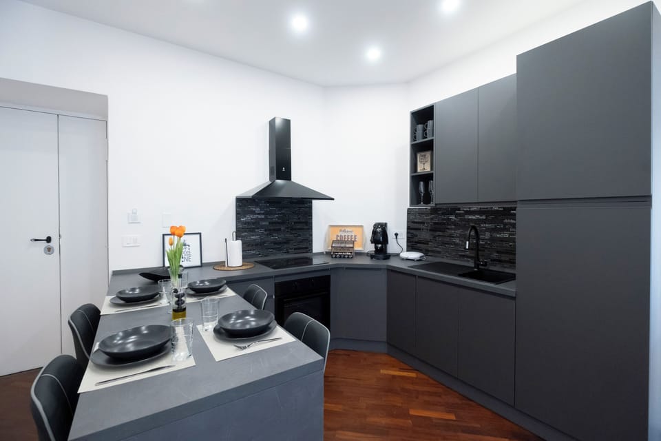Family Suite, Balcony, City View | Private kitchen | Espresso maker, electric kettle, cleaning supplies, dining tables