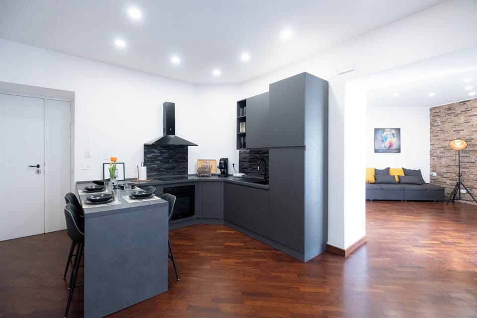 Family Suite, Balcony, City View | Private kitchen | Espresso maker, electric kettle, cleaning supplies, dining tables